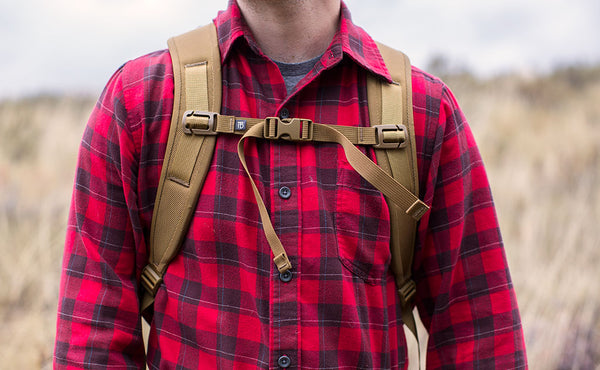 A person wearing the Guide's Pack with the sternum strap clipped.